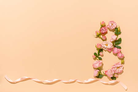 International Women's Day. Flower composition 8. Creative date. Heads of delicate roses on a light pastel beige background. Mockup postcard Mother's Day, March 8. Spring flower background, copy spaceの写真素材
