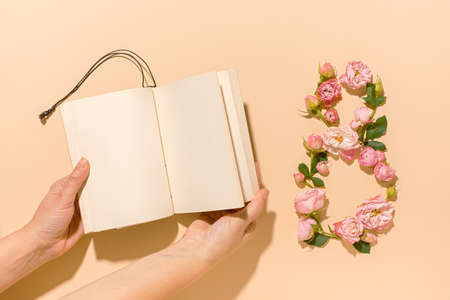 International Women's Day. Flower composition 8. Creative date. Heads of delicate roses on a light pastel beige background. Mockup postcard Mother's Day, March 8. Spring flower background, copy spaceの写真素材