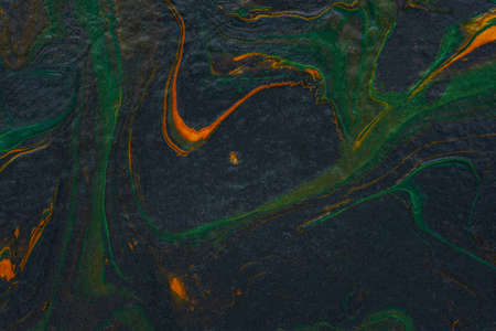 Black orange green fluid art. Abstract acrylic painting background. modern marble texture. The concept of natural texture, creative wave. Fashion art, mockup for booklets, covers, notebooks, bannersの写真素材