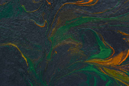 Black orange green fluid art. Abstract acrylic painting background. modern marble texture. The concept of natural texture, creative wave. Fashion art, mockup for booklets, covers, notebooks, bannersの写真素材