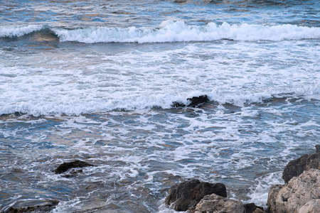 Pastel-gray sea. texture of a raging ocean, full frame with space for text. The concept of weather, vacation, travel. The purest clear sea water, big waves close-up. Calm natural light gray backgroundの写真素材