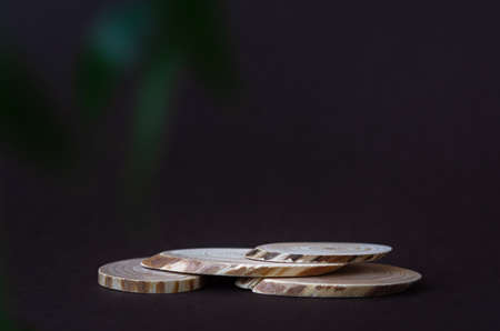 Wooden podium pedestal. Brown background dark green leaves. Product display concept. Mockup for cosmetic products, eco-goods and production. Marketing is natural. Minimalism with wooden sections.の写真素材