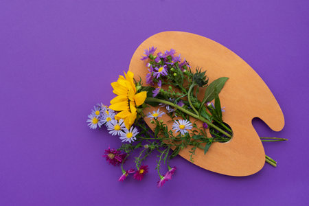 Autumn flower arrangement purple background wooden palette. Bouquet of colorful autumn flowers. Creative vertical greeting card. The layout for the design of greetings, the concept of the Mother's Dayの写真素材
