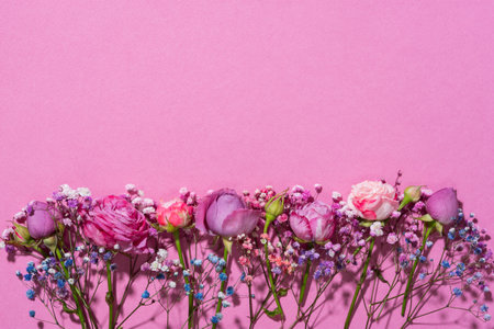 Flower composition pink flowers. A delicate bouquet of pink flowers on a pink pastel background. The concept of congratulations, romance. A postcard for Valentine's Day, Mother's Day. Flat lay, mockupの写真素材