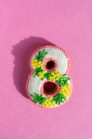 March 8 cake on a colorful fashionable pink background. Sweet gift dessert for Women's Day, Birthday, anniversary. Spring colorful design in natural sunlight. creative greeting card. top viewの写真素材