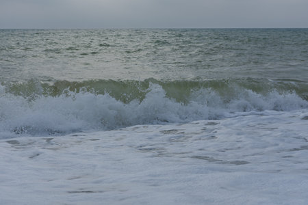Pastel-gray sea. texture of a raging ocean, full frame with space for text. The concept of weather, vacation, travel. The purest clear sea water, big waves close-up. Calm natural light gray backgroundの写真素材