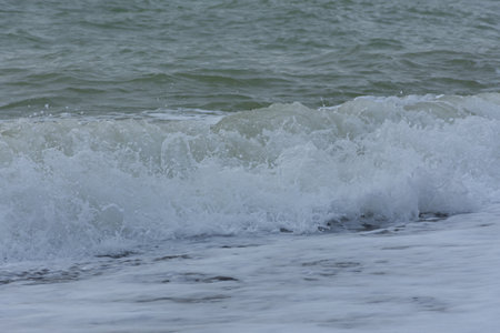 Pastel-gray sea. texture of a raging ocean, full frame with space for text. The concept of weather, vacation, travel. The purest clear sea water, big waves close-up. Calm natural light gray backgroundの写真素材