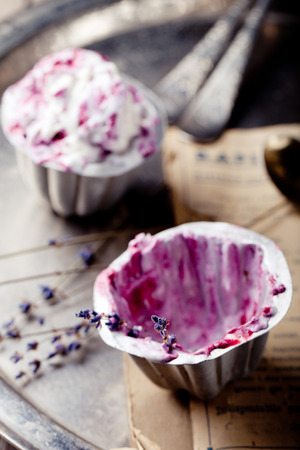 Berry ice cream in vintage cups  with lavender flowers on a wooden backgroundの写真素材