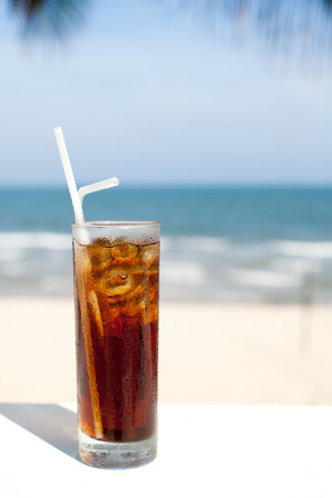 Iced soda drink in a glass on a sea, ocean, beach , summer backgroundの写真素材