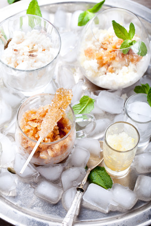 Black tea flavor, milk and lemon granita, sorbet in a glass with brown sugar crystalsの写真素材