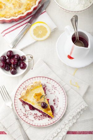 Cherry pie homemade on a white textile backgroundの写真素材