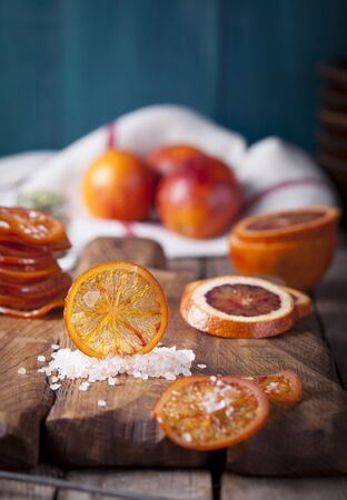 Sicilian Bloody oranges candied slices on a wooden cutting boardの写真素材