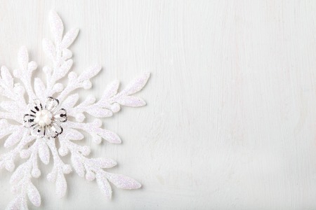 Christmas and New Year background. Snowflake on a white wooden background. Copy space.の写真素材