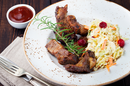 Grilled sliced barbecue pork ribs with cabbage salad cole slawの写真素材