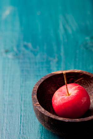 Red apples and leaves on a wooden blue, turquoise backgroundの写真素材