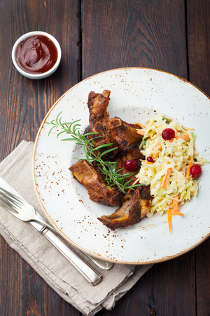 Grilled sliced barbecue pork ribs with cabbage salad cole slawの写真素材