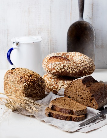 Assortment of rustic bread on wooden table background Composition with bread slices and rolls Copy...