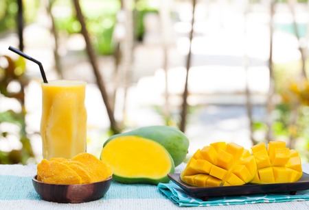 Fresh and dried mango fruit with smoothie juice on a outdoor tropical background Copy spaceの写真素材