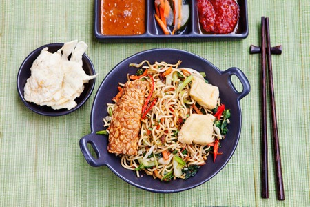 Mi goreng,mee goreng Indonesian cuisine, spicy stir fried noodles with tempeh and assortment of asian sauces Top viewの写真素材