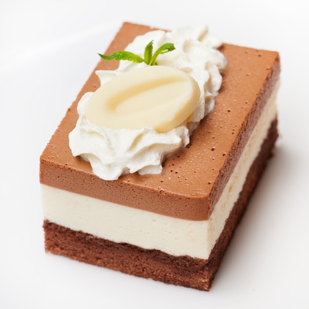 Three chocolate mousse cake on a white plate Outdoor background