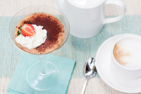 Tiramisu, traditional Italian dessert with strawberry on a blue napkinの写真素材