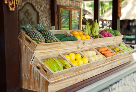 Juice Bar with assorted fresh fruits and vegetables. Tropical summer outdoor backgroundの写真素材