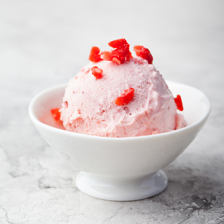 Strawberry sundae ice cream in bowl on white stone background Copy spaceの写真素材