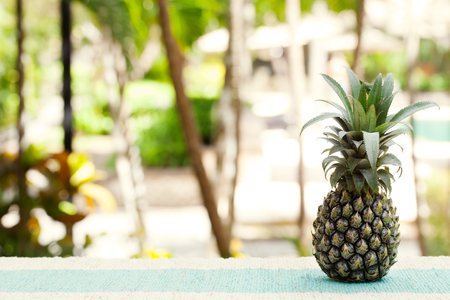 Pineapple on wooden table Tropical summer background Copy spaceの写真素材
