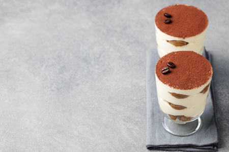 Tiramisu, traditional Italian dessert in glass on a grey stone background Copy spaceの写真素材