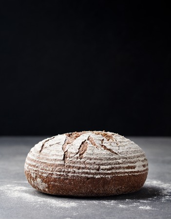 Rye, whole grain bread on a grey stone background. Copy spaceの写真素材