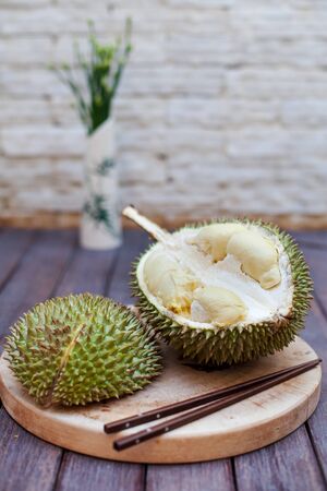 Durian fruit, Mon Thong on wooden cutting board. Outdoor background. Copy space