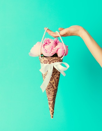 Bunch of peonies flowers in female hand Copy spaceの写真素材