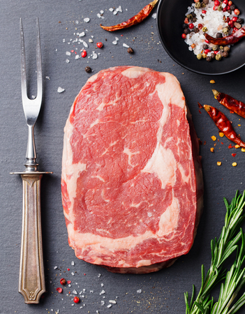 Raw beef steak. Meat piece. Top view. Copy space. Slate cutting board