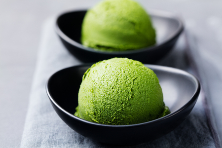 Matcha ice cream scoop in bowl. Stone background.の写真素材