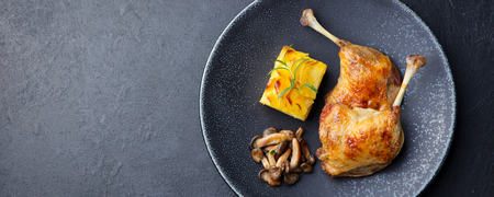 Duck legs confit with potato gratin and mushroom sauce. Restaurant serving. Copy space. Top viewの写真素材