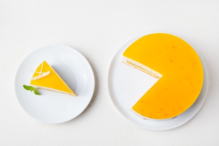 Passion fruit cake, mousse dessert on a white plate. Top view