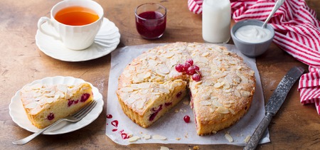 Almond and raspberry cake, Bakewell tart. Traditional British pastry. Wooden backgroundの写真素材