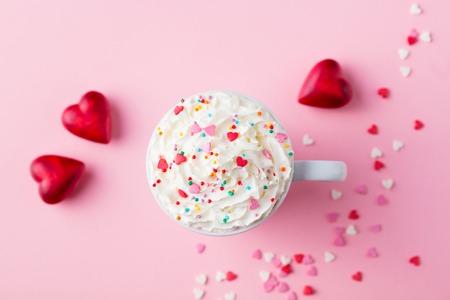 Romantic drink, coffee, latte, cappuccino with whipped cream. Top view. Pink background.の写真素材