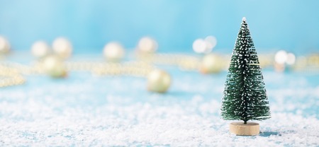 Christmas, New Year blue background with snow and green eve ornaments. Copy space.の写真素材