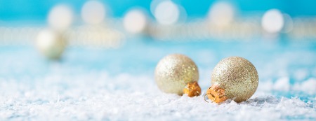 Christmas golden balls with snow decoration on blue background. Copy space.の写真素材
