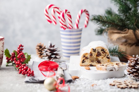 Christmas stollen cake with icing sugar, marzipan and raisins. Traditional Dresdner christ pastry.の写真素材