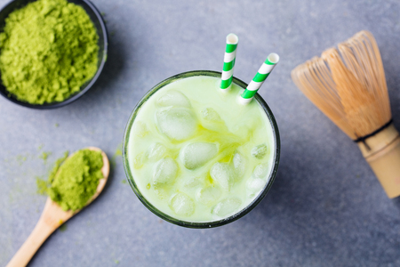 Matcha green tea ice latte with matcha powder and bamboo whisk. Top view.の写真素材