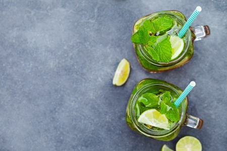 Mojito cocktail in glass jars on grey stoneの写真素材
