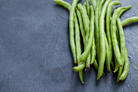 Green beans on grey stoneの写真素材