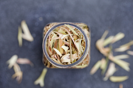 Lemongrass in a jar on grey stoneの写真素材