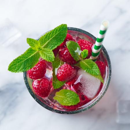 Raspberry cocktail, fizz, lemonade, ice tea with fresh mint. Close up. Top view.の写真素材