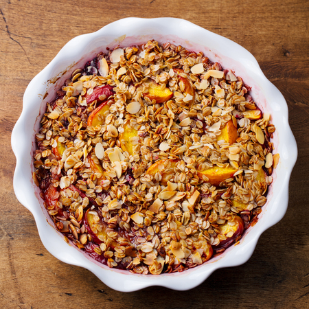 Berry, peach crumble, crisp in a baking dish.の写真素材