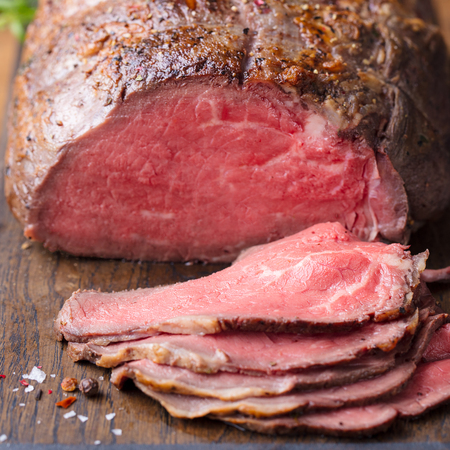 Roast beef on cutting board.の写真素材