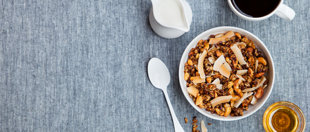 Healthy breakfast. Fresh granola, muesli with coconut, banana and nuts.の写真素材