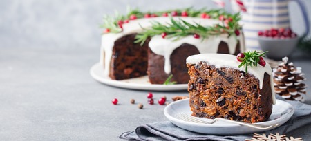 Christmas fruit cake, pudding on white plate. Copy space.